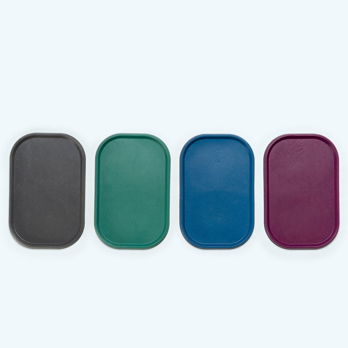 Four rectangular trays in black, green, blue, and purple on a white background