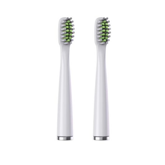 Two white toothbrush heads with green bristles on a white background
