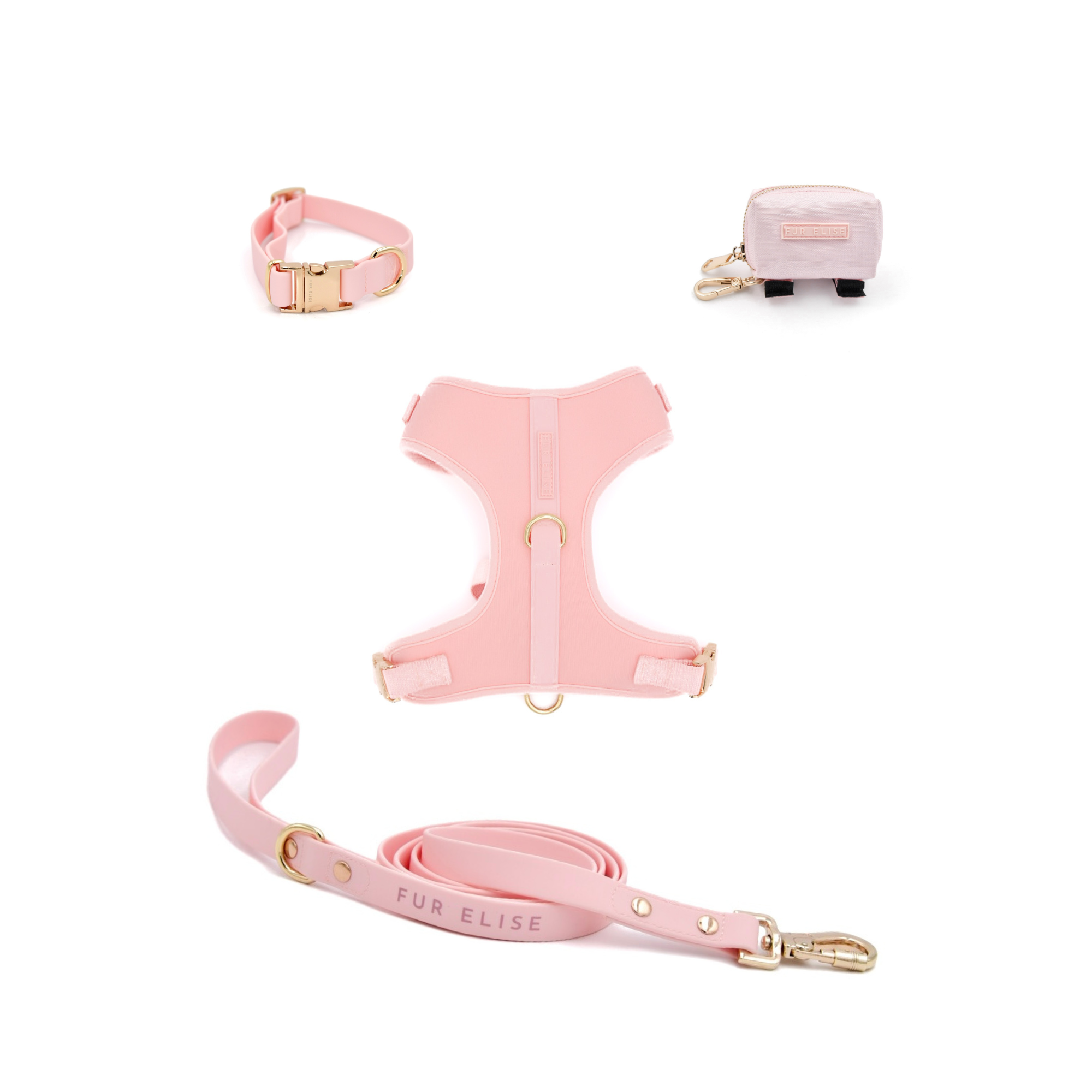 Pink dog harness, leash, and collar set with gold hardware on a white background