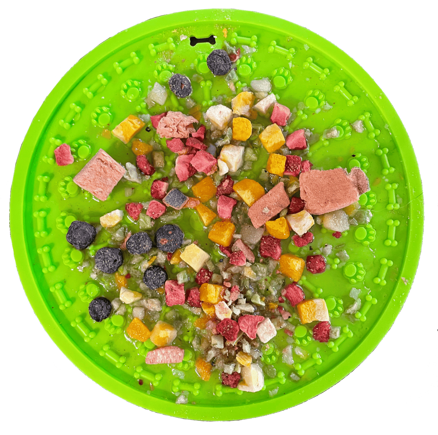Green pet food puzzle mat with various dog treats on a white background