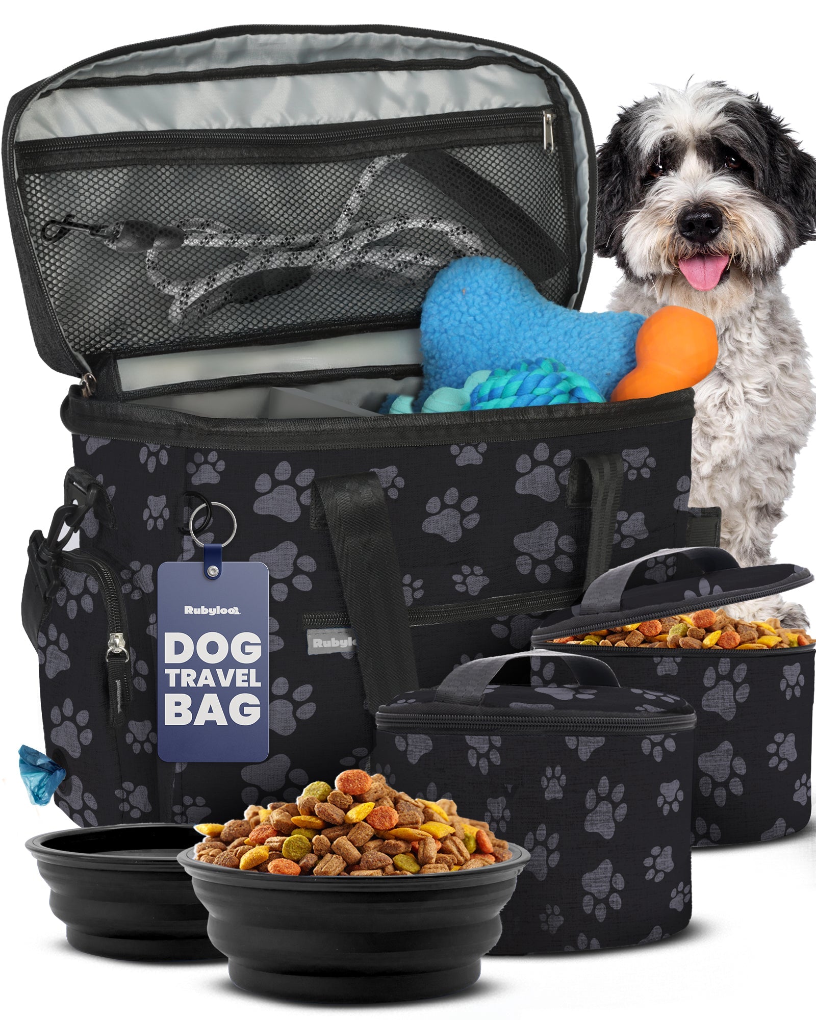 Dog travel bag with pet supplies including bowls, food, and a toy, with a dog standing next to it.