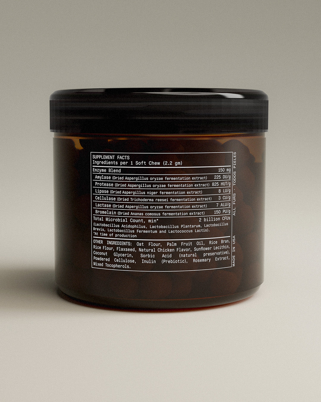 Brown container with black lid on a beige background