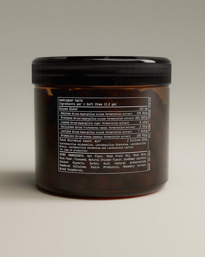 Brown container with black lid on a beige background