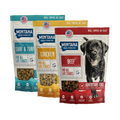 Three packages of Montana Dog Food Co. dog food on a white background