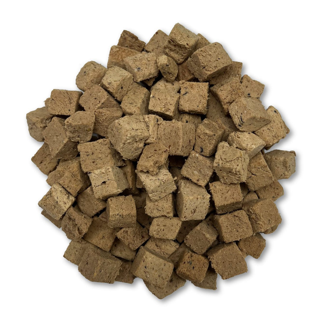 Pile of brown square pet food on a white background