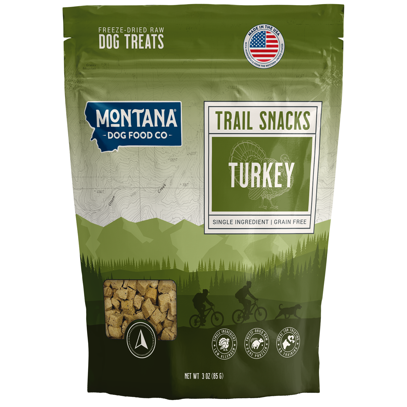 Green package of Montana Dog Food Co. trail snacks with turkey flavor on a white background