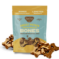 Package of 'Sweet Potato Cheese Drizzled Bones' dog treats with treats displayed in front.