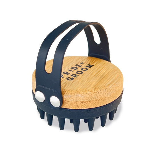 Pet grooming tool with wooden top and black rubberized sides on a white background