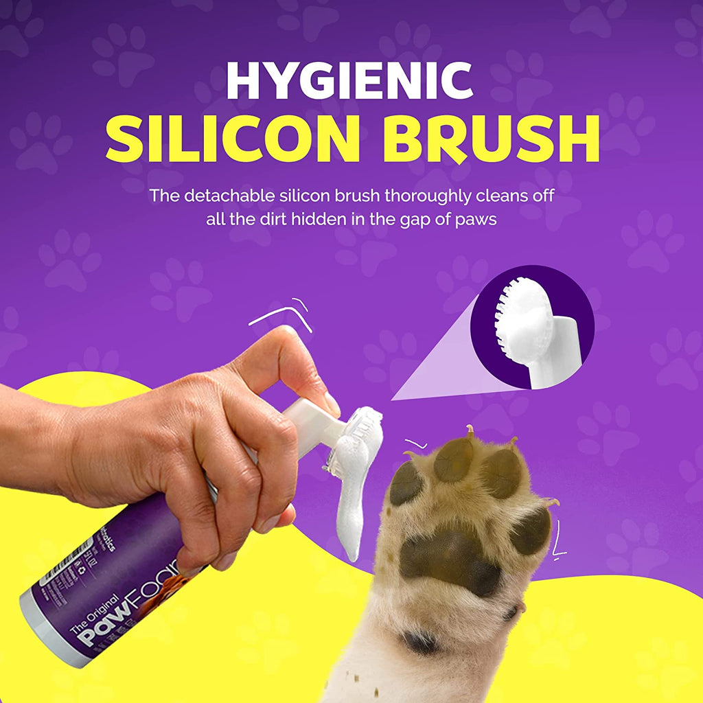 Hygienic silicon brush for pets with a hand holding the brush and a dog's paw on a purple and yellow background.