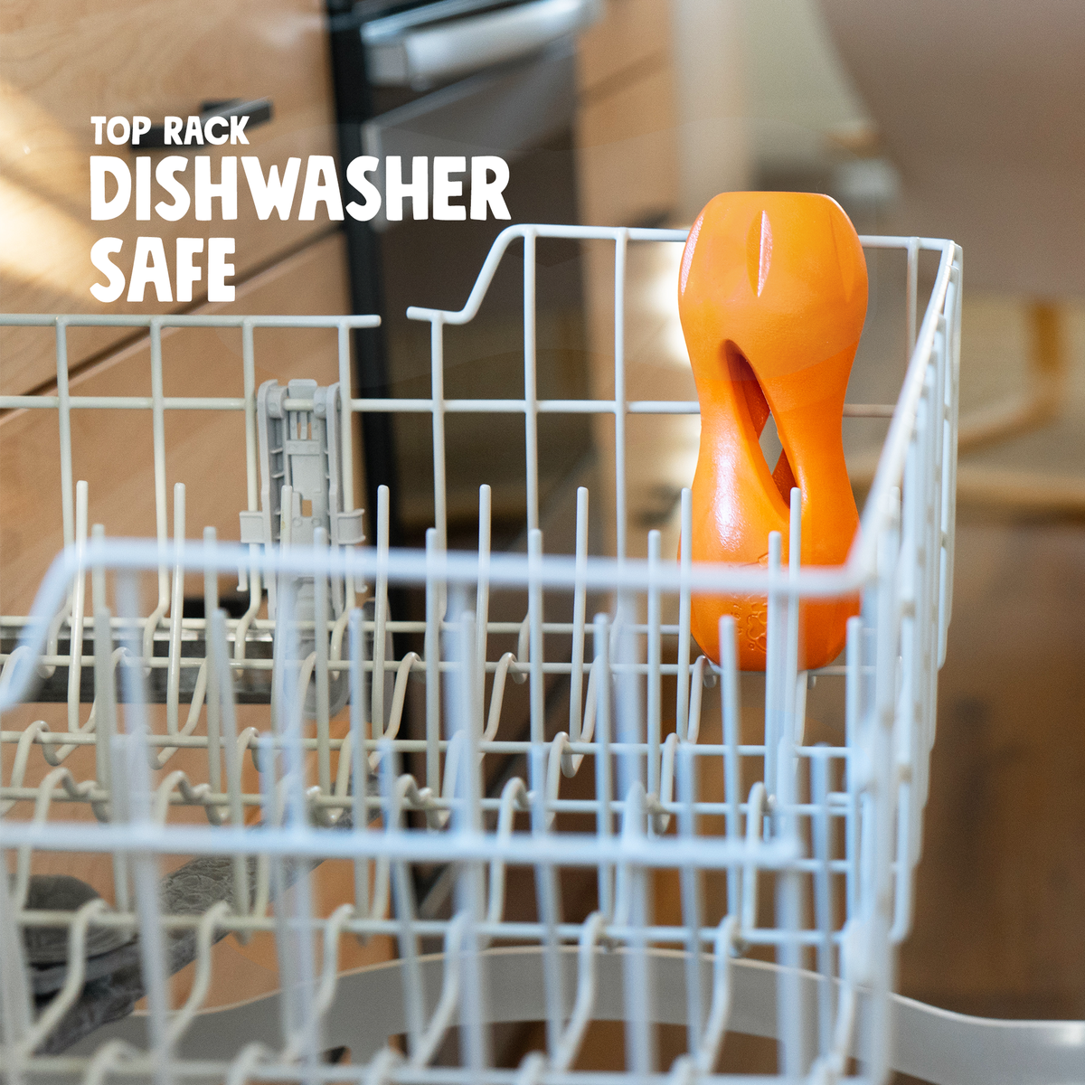 Orange dish scrubber in a dishwasher rack with text 'Top Rack Dishwasher Safe'.