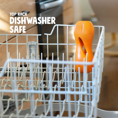 Orange dish scrubber in a dishwasher rack with text 'Top Rack Dishwasher Safe'.