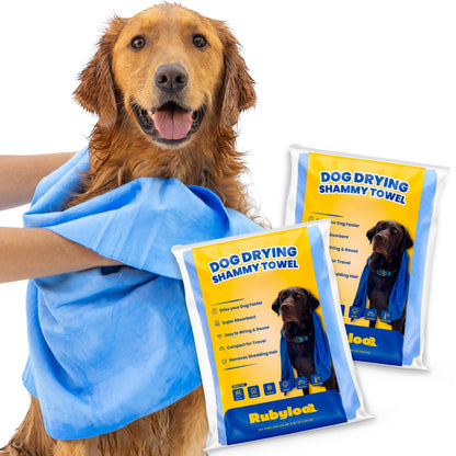 Dog wrapped in a blue shammy towel with RubyLove packaging in the foreground