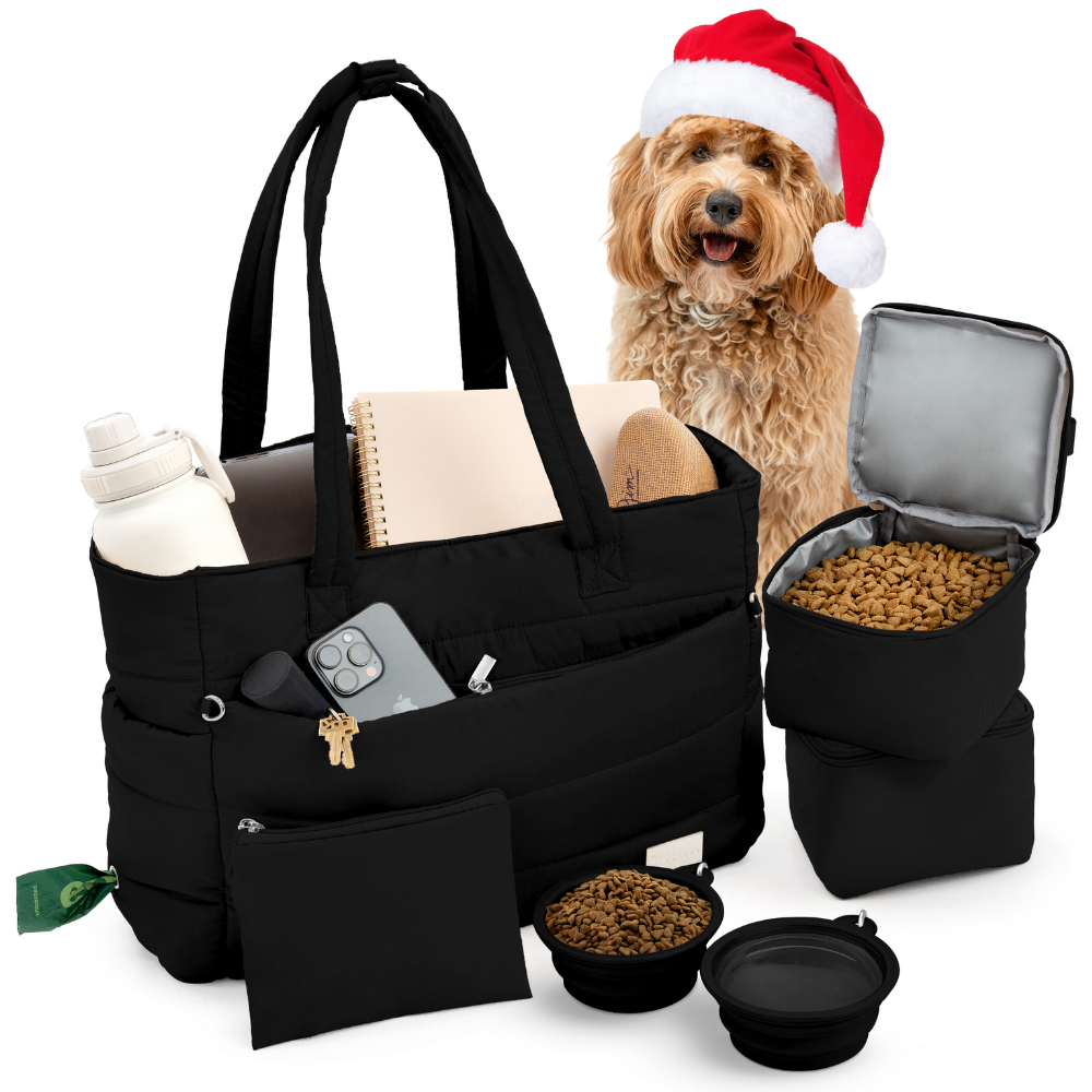 Black pet travel bag with a dog wearing a Santa hat, food bowls, and treats on a white background.