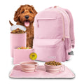 Pink pet travel set with backpack, bowls, and food container on a white background
