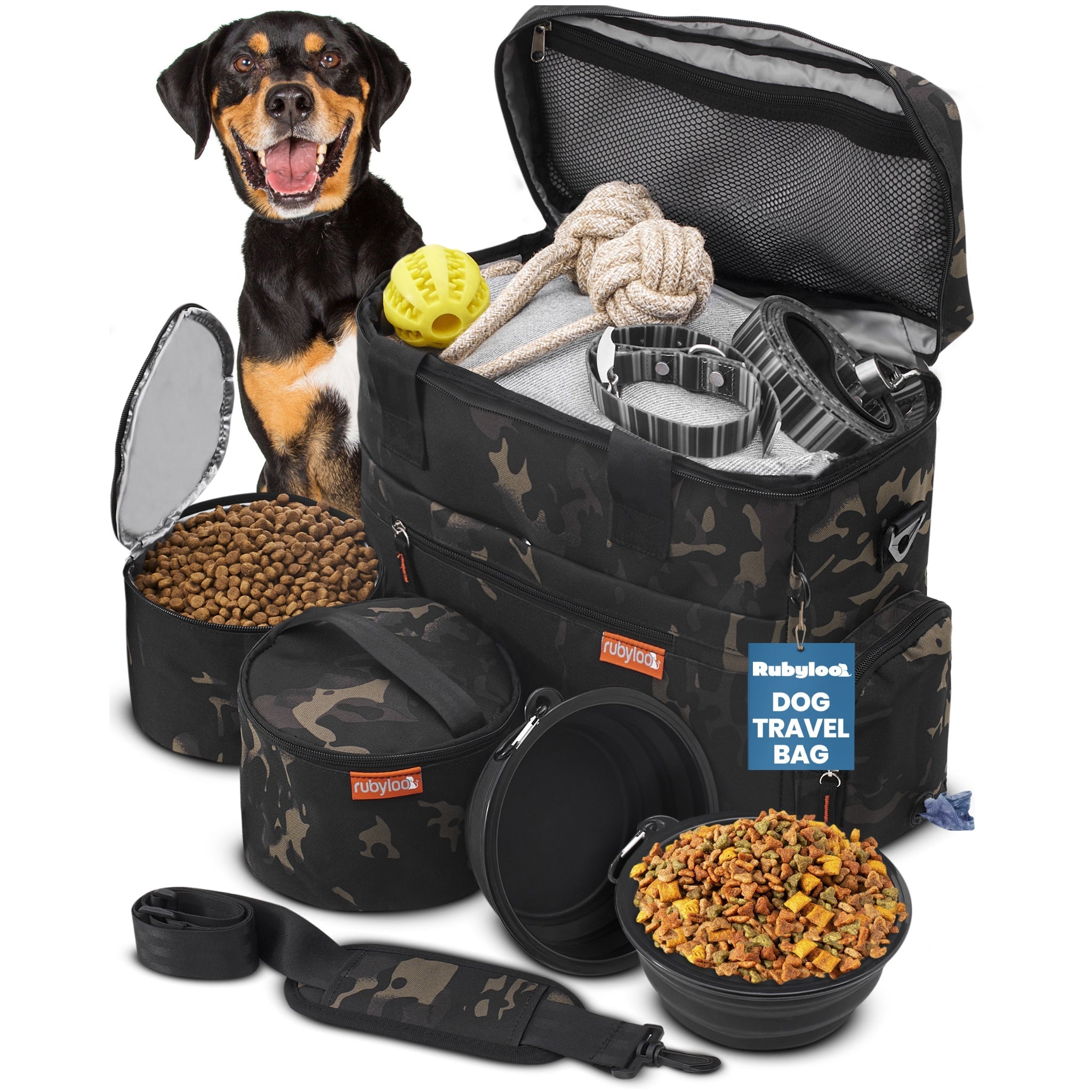 Dog travel bag with dog food, toys, and a dog sitting next to it on a white background.
