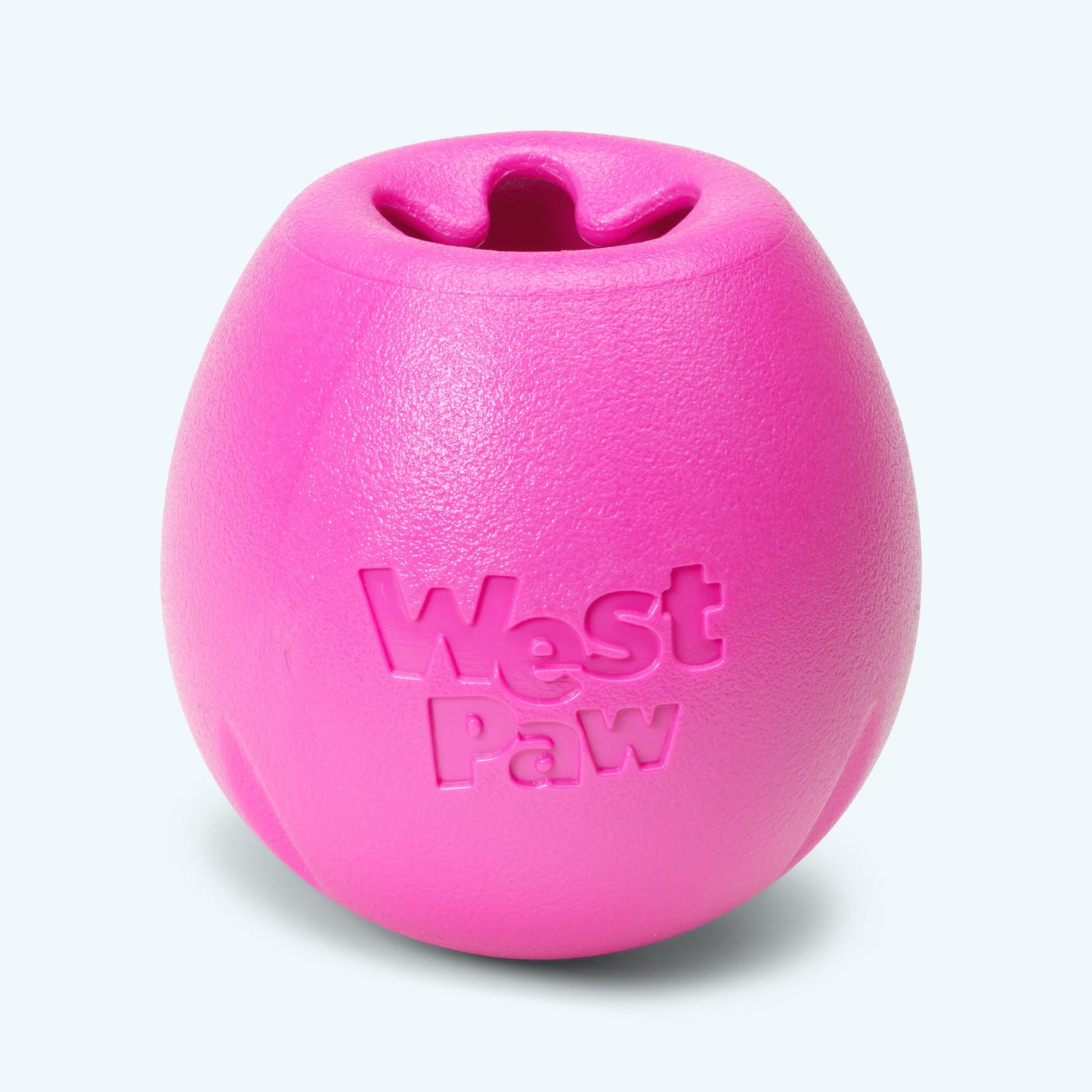 Pink dog toy with 'West Paw' branding on a light gray background