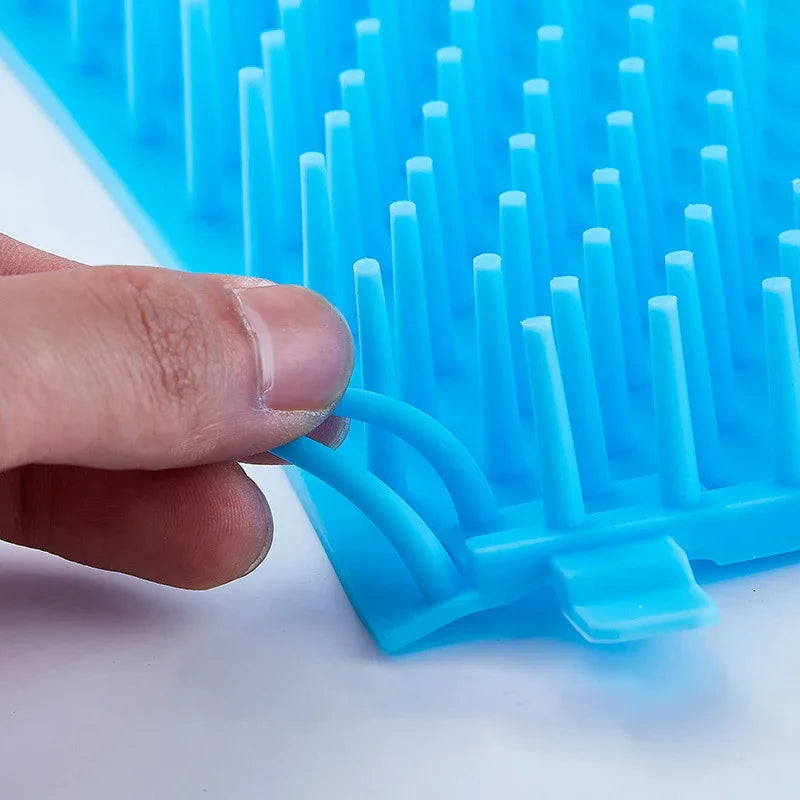 Blue silicone mold with a hand holding it on a white background