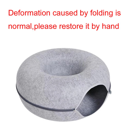 Gray pet house with text indicating normal folding deformation and instructions to restore it by hand on a white background.