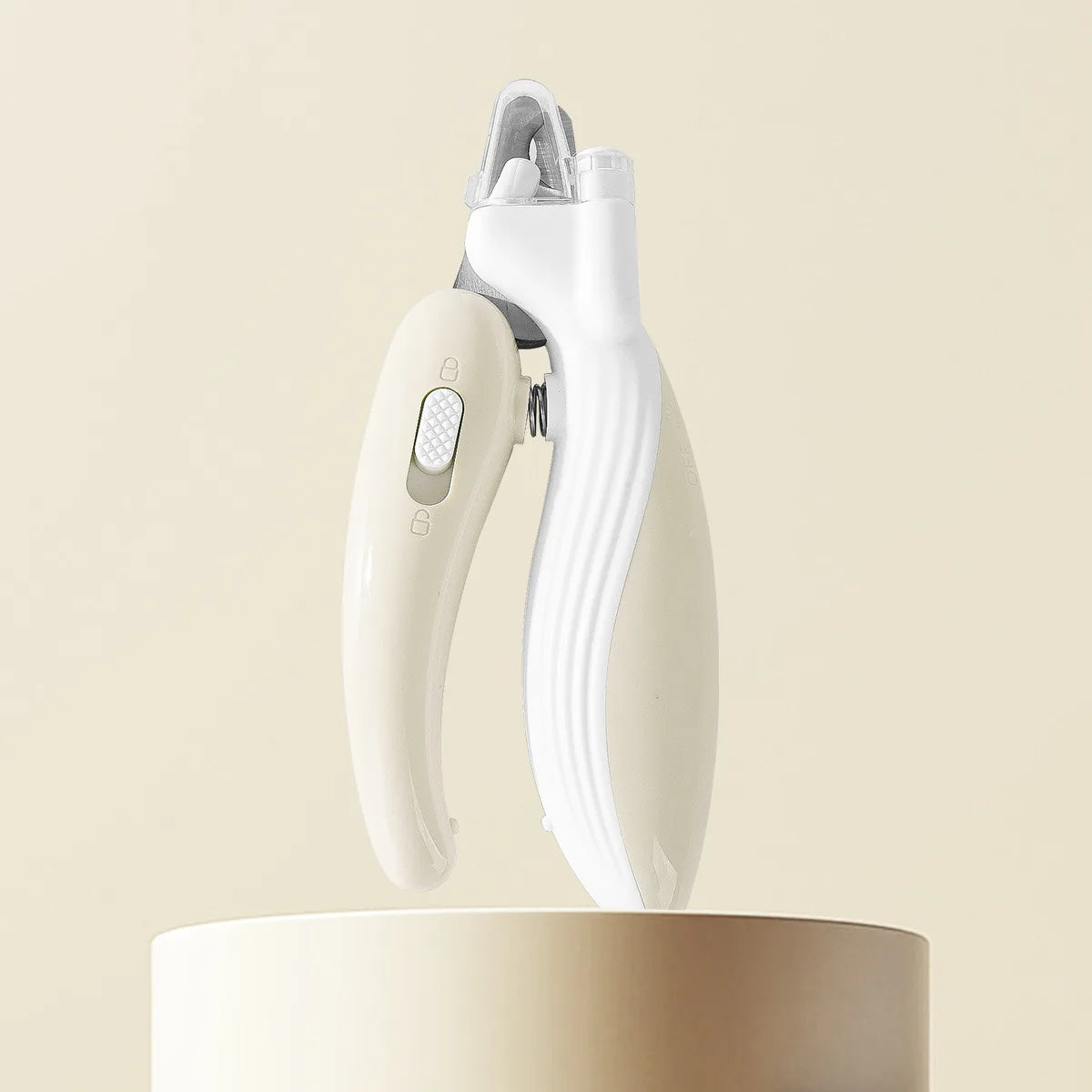 White pet nail clipper on a beige background