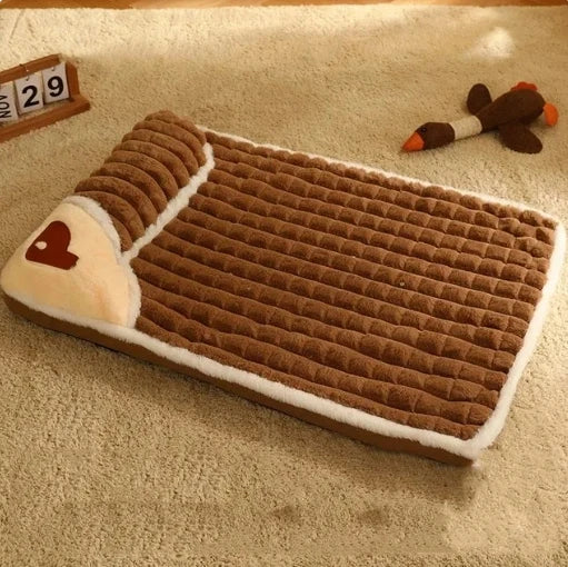 Brown pet bed with heart design on a beige carpet