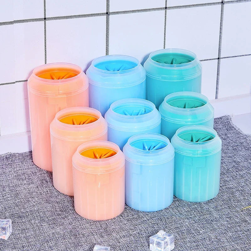 Set of colorful cylindrical containers with lids on a textured surface.