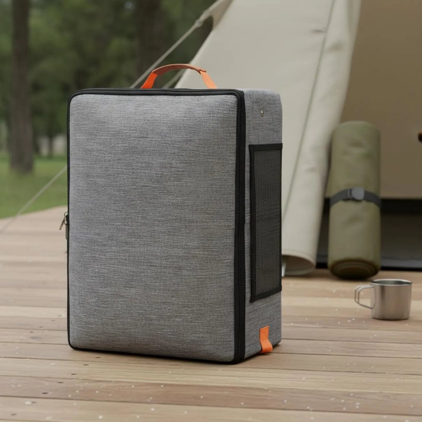 Gray cooler bag with orange accents on a wooden deck with a tent in the background