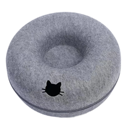 Gray donut-shaped pillow with a black cat silhouette on a white background