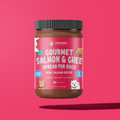 Jar of Gourmet Salmon & Ghee Spread for Dogs on a pink background