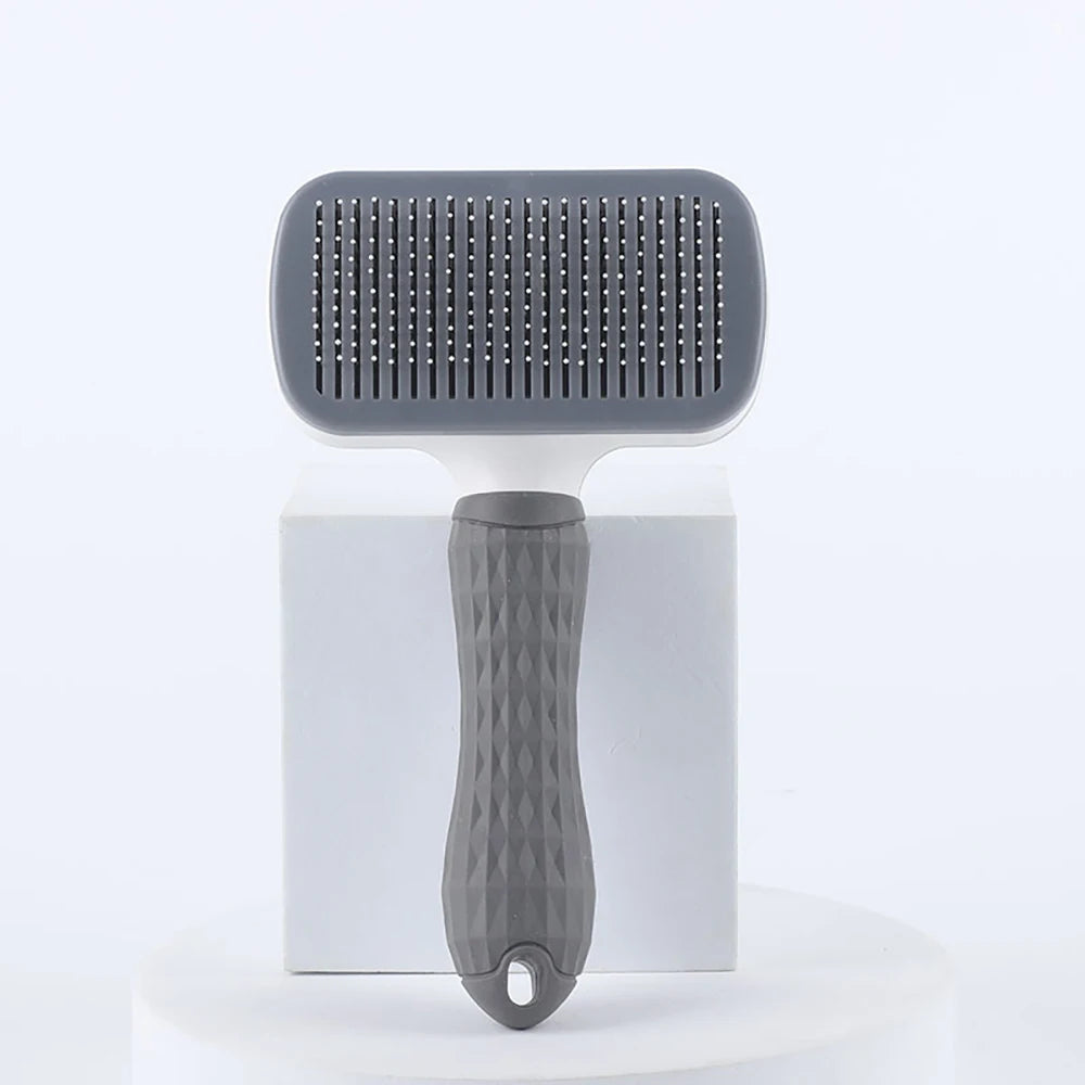 Gray pet grooming brush on a white background
