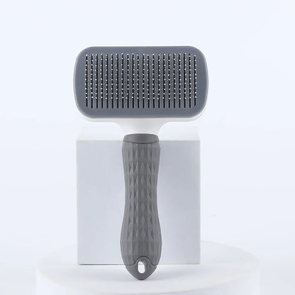 Gray pet grooming brush on a white background