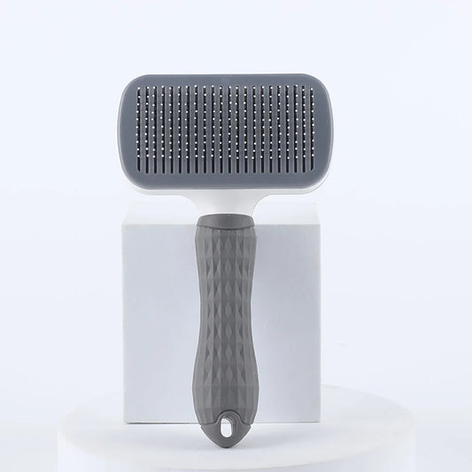 Gray pet grooming brush on a white background