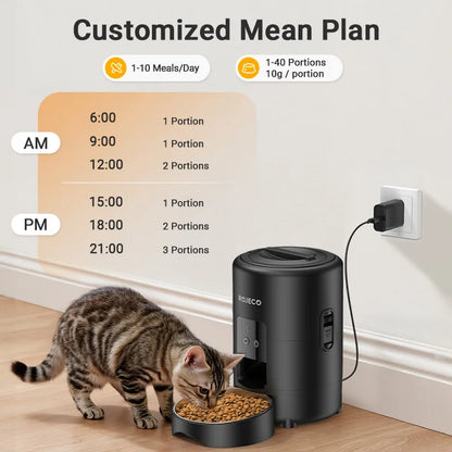 Cat eating from a black pet feeder with a meal plan chart in the background.