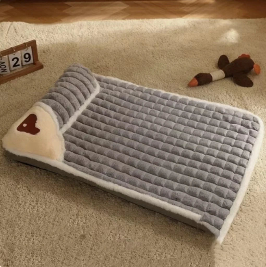 Gray pet bed with a heart design on a carpeted floor.