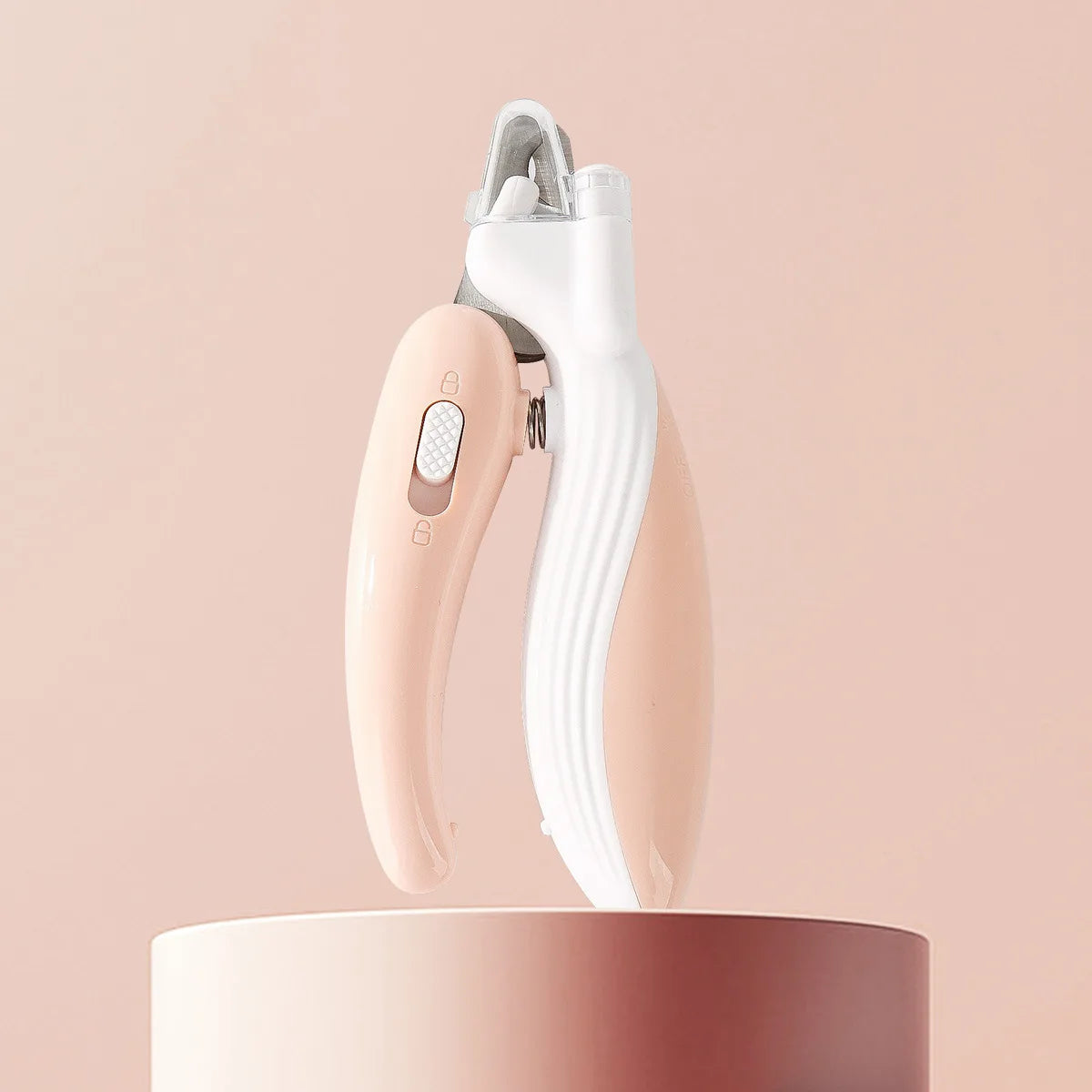 White and rose gold electronic device on a pink background