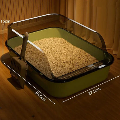 Green cat litter box with dimensions on a wooden floor