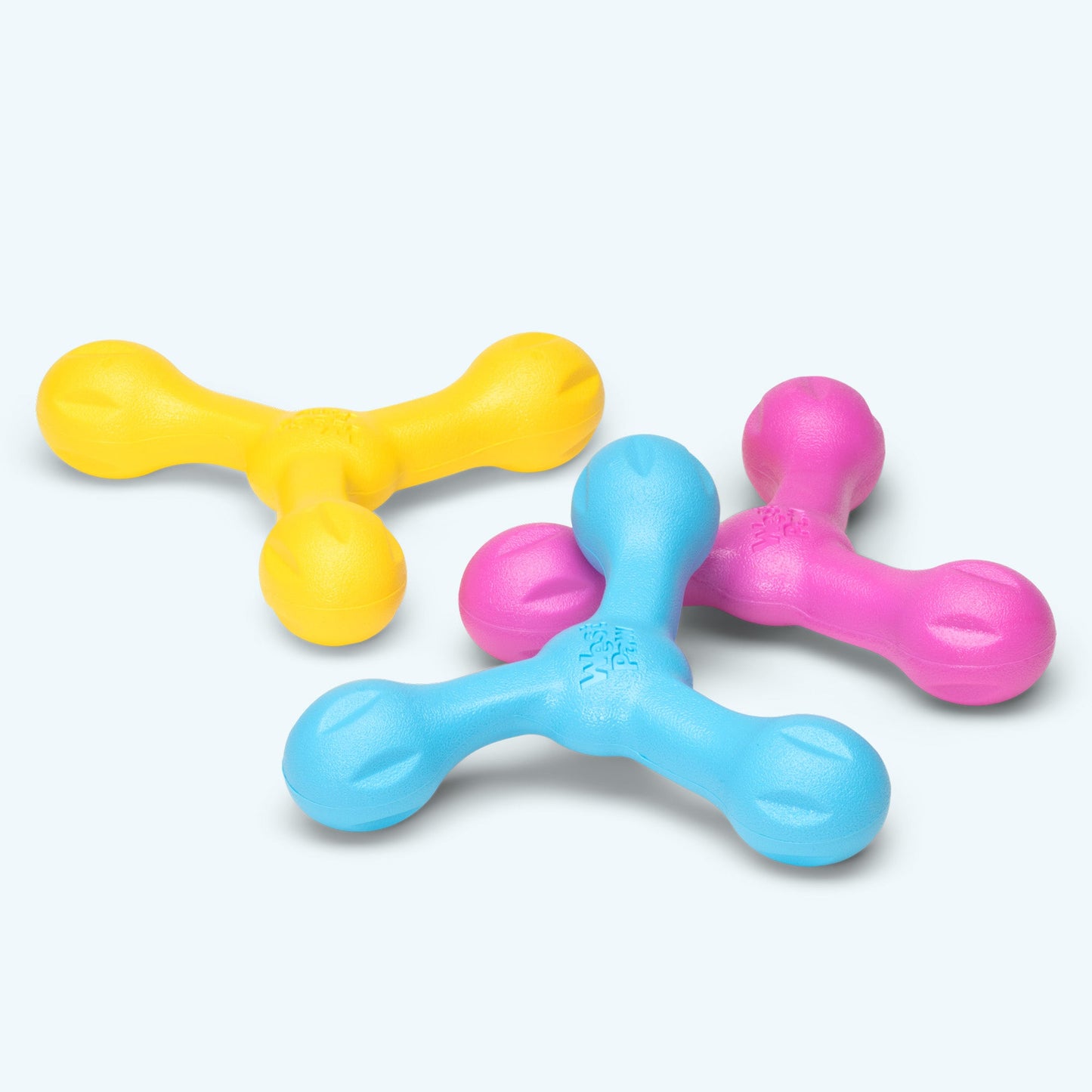 Three colorful plastic toys on a white background