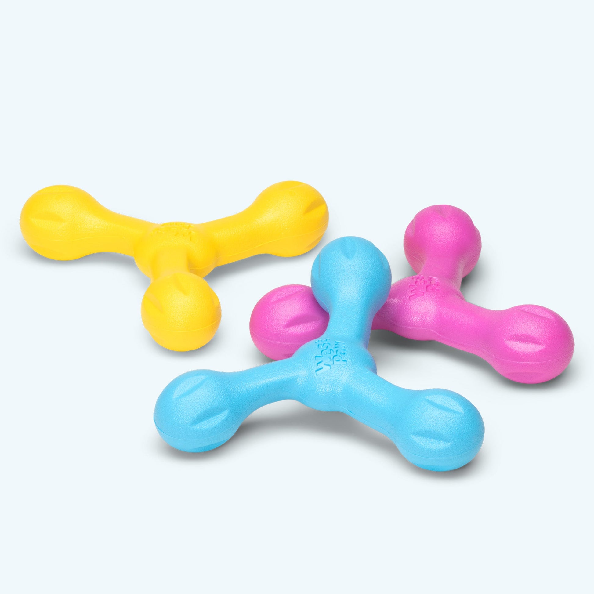 Three colorful plastic toys on a white background