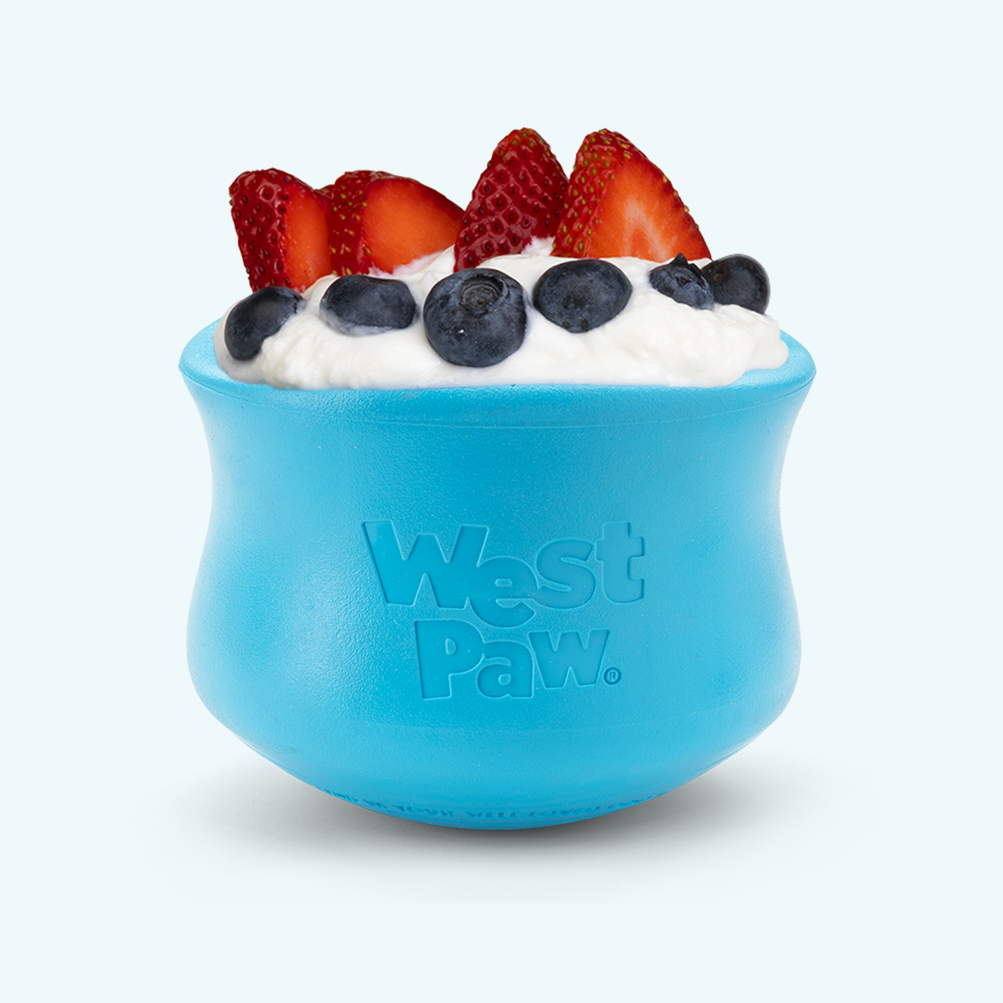 Blue West Paw dog toy with yogurt and berries on a white background