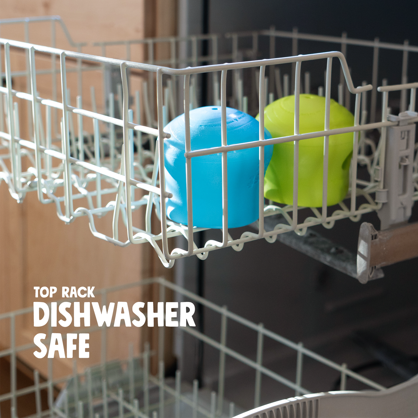 Two colorful objects in a dishwasher rack with 'Top Rack Dishwasher Safe' text.
