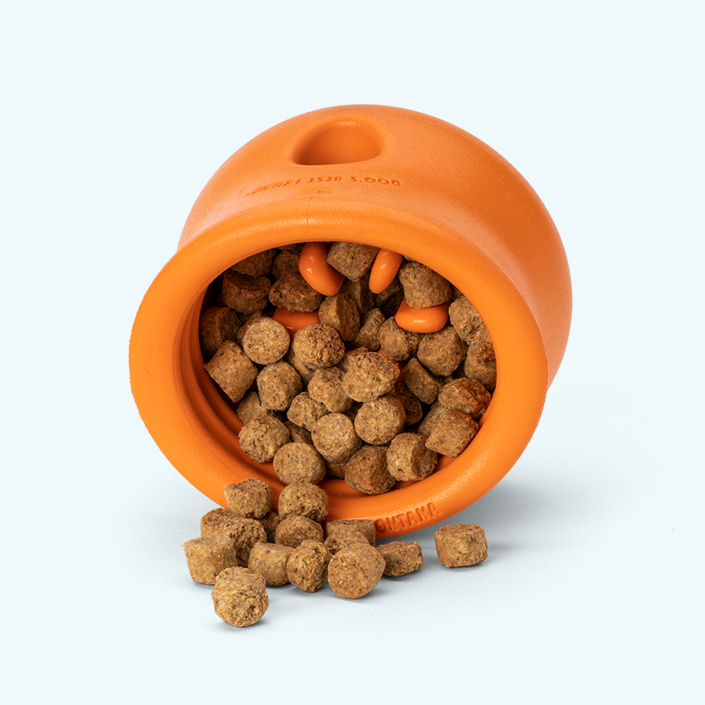 Orange dog toy with treats on a white background