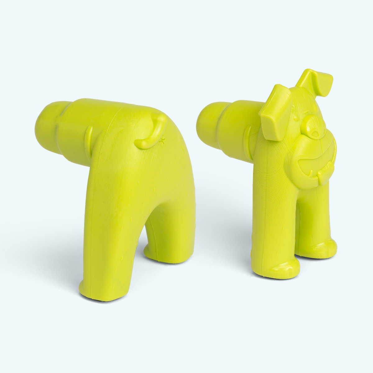 Two yellow plastic toys resembling animals on a white background