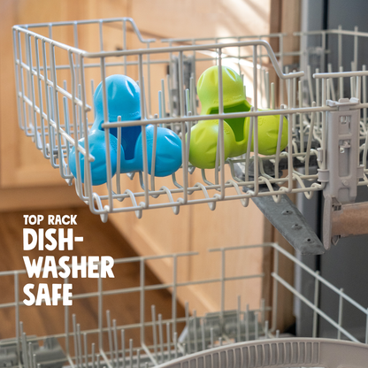 Blue and green dog toys in a dishwasher rack with text 'Top Rack Dishwasher Safe'.