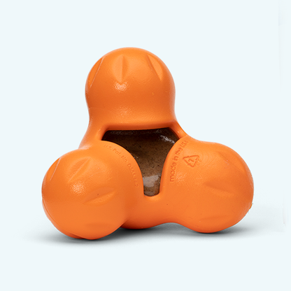 Orange dog toy with a textured surface on a white background