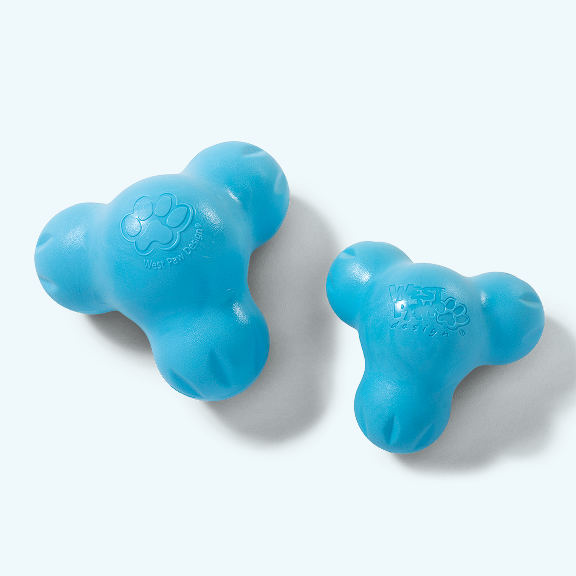 Two blue dog toys on a white background