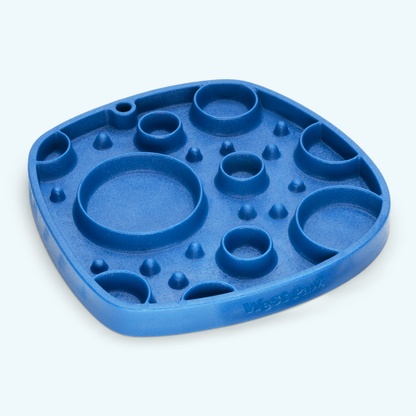 Blue silicone mold with various compartments on a light gray background