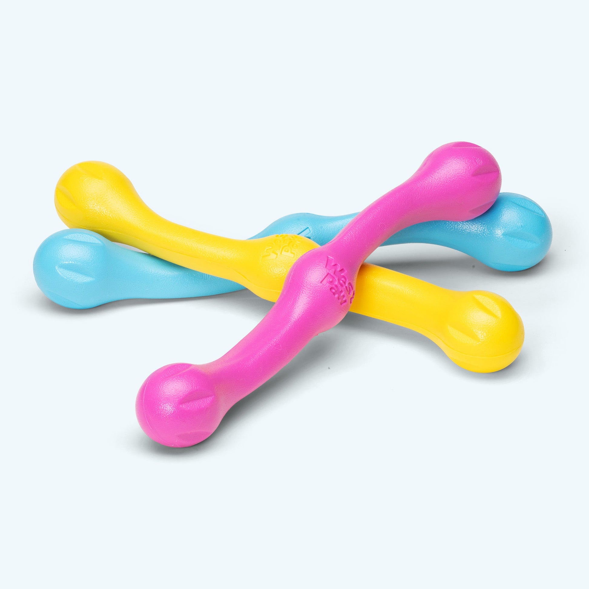 Colorful plastic toy with pink, yellow, and blue components on a white background