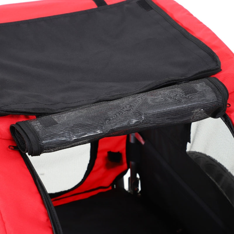 Close-up of a red and black inflatable boat with a rolled-up black mat on top.
