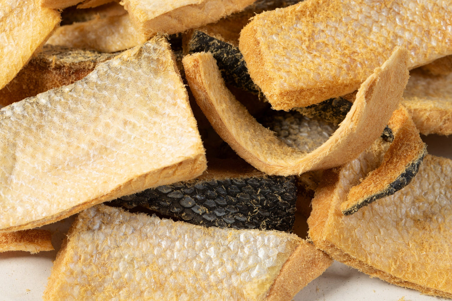 Close-up of dried fish pieces on a white background