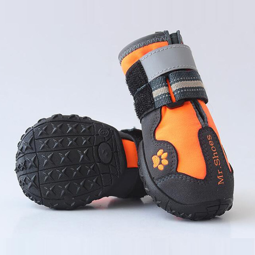 Orange and gray pet shoes with black soles on a light gray background