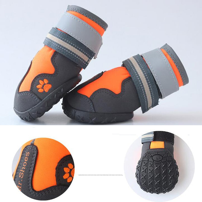 Orange and gray dog shoes with paw print design on a white background
